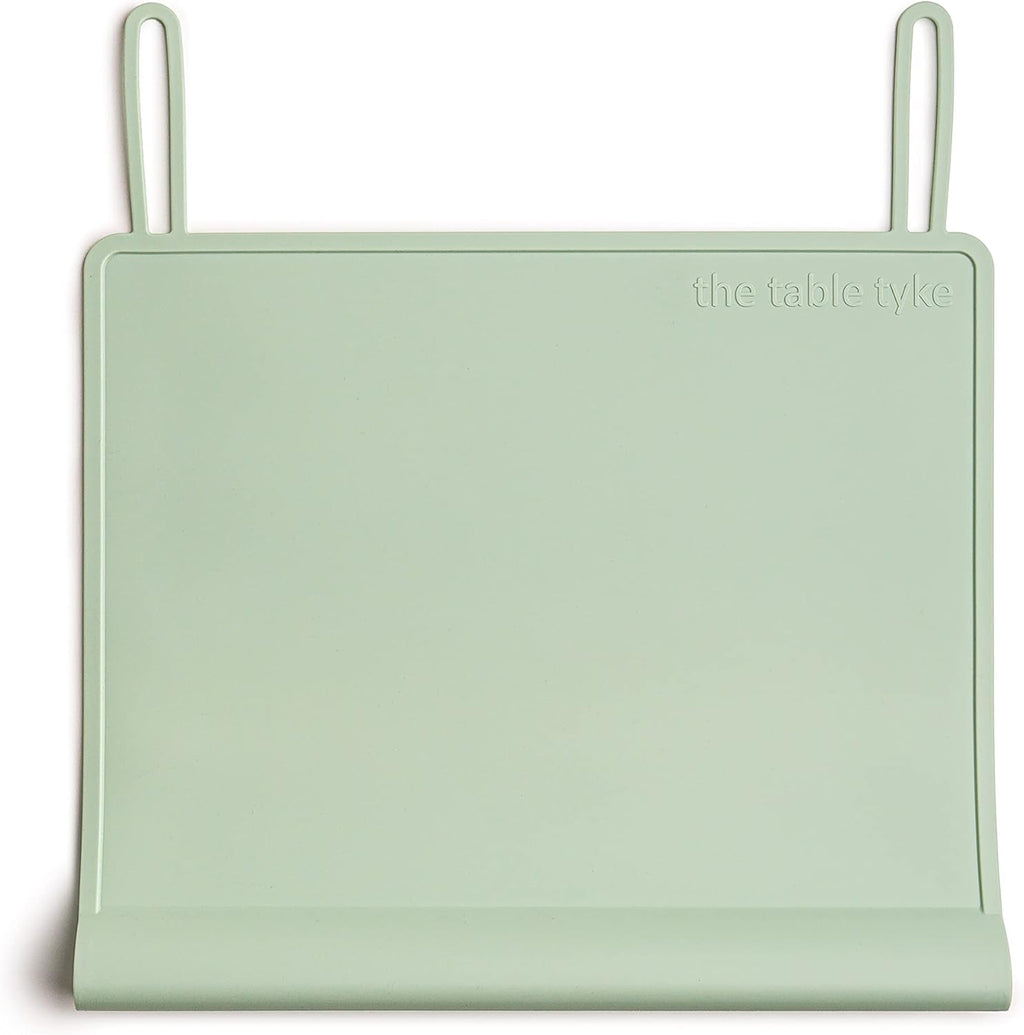 The Table Tyke Silicone Placemat Sage Green front view showcasing the patented table edge bumper on a wooden dining table