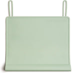 The Table Tyke Silicone Placemat Sage Green front view showcasing the patented table edge bumper on a wooden dining table