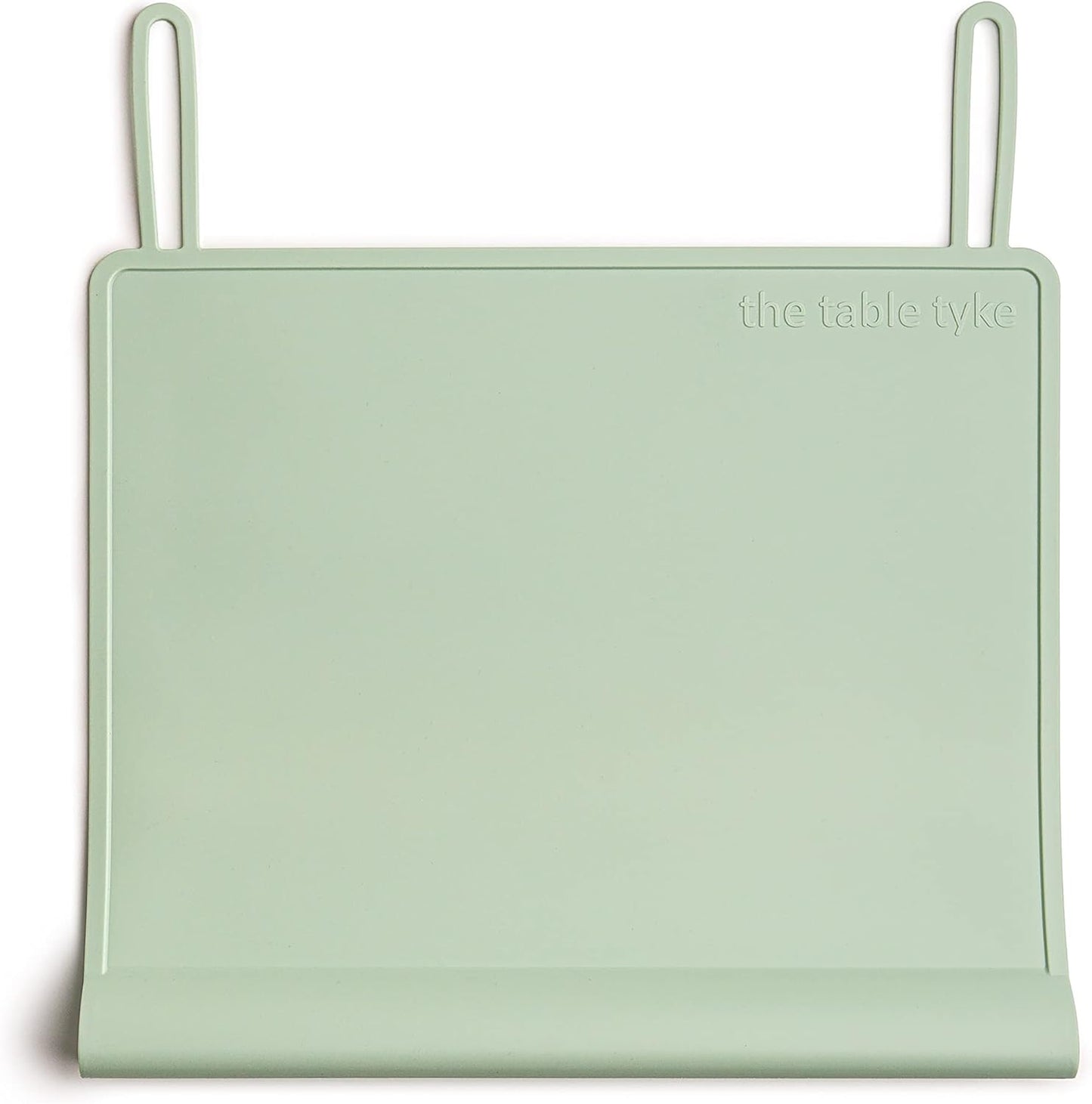 The Table Tyke Silicone Placemat Sage Green front view showcasing the patented table edge bumper on a wooden dining table