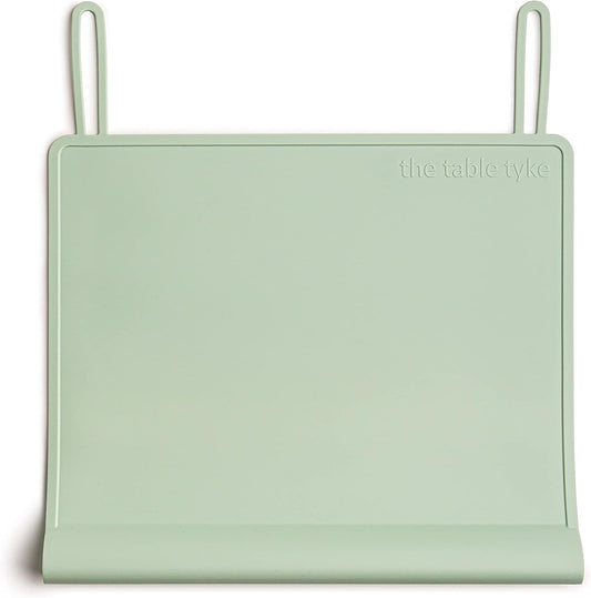 The Table Tyke Silicone Placemat Sage Green front view showcasing the patented table edge bumper on a wooden dining table