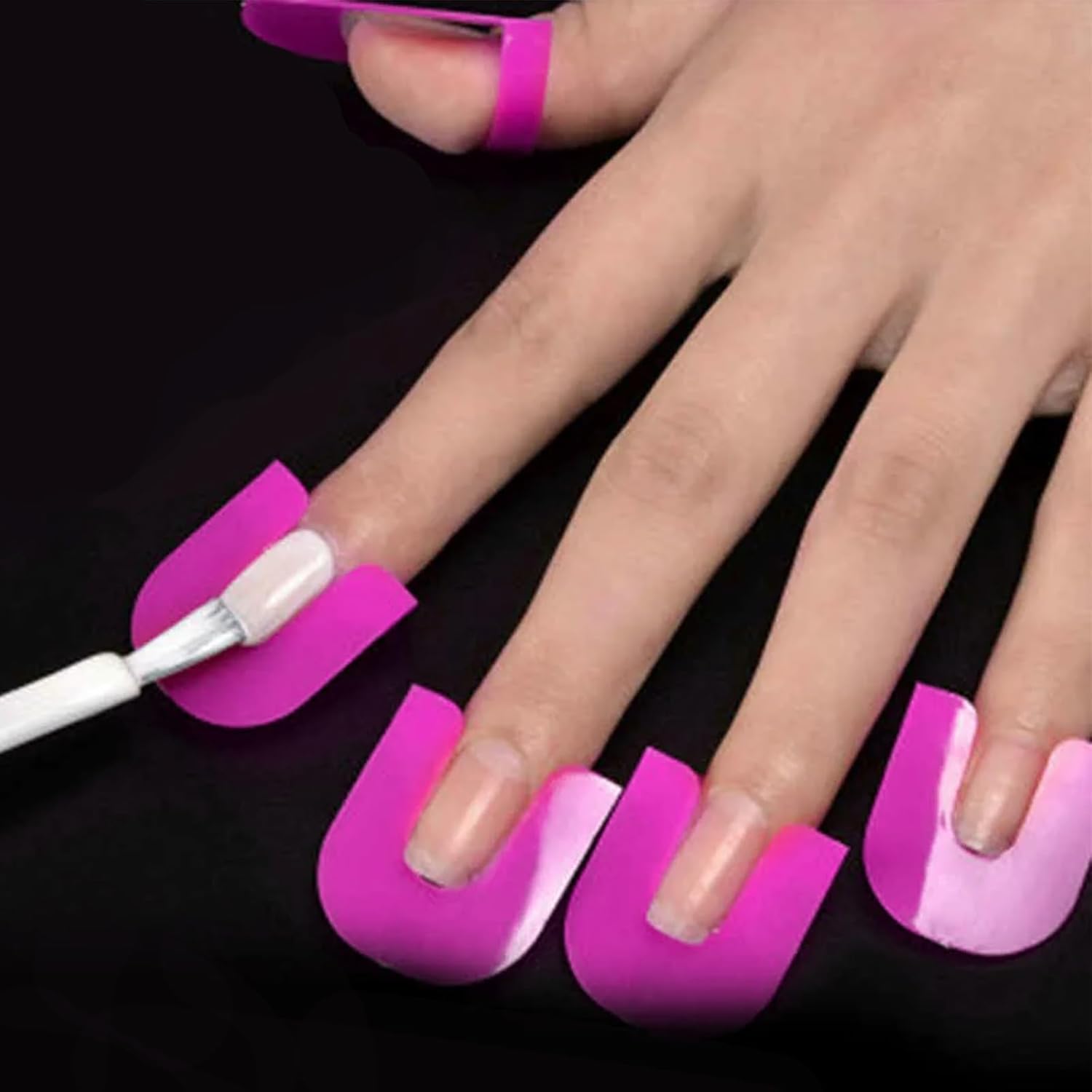 PPX nail polish protector tools pack showing multiple pink U-shaped plastic stencils on a white background.