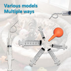 Flexible PVC feeding tubes laid out next to a small animal syringe bulb accessory.