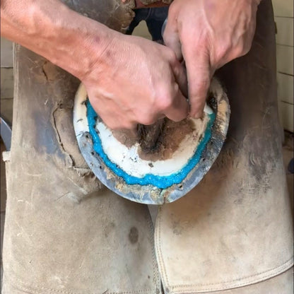 Easy application of the USA imported equine hoof treatment into a horse hoof crevice.
