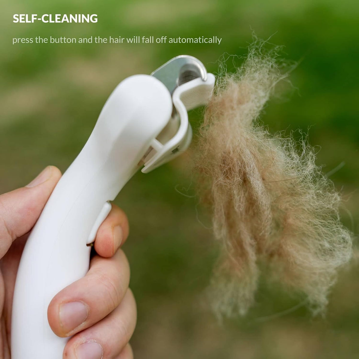 Taomypets grooming tool held in hand for scale