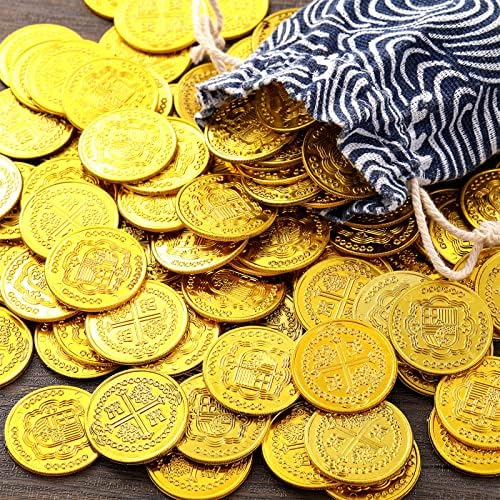 Close up view of embossed skull motif on shiny gold plastic doubloon replicas.