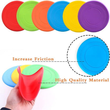 Dogs playing with colorful Bvrbaory flying discs outdoors