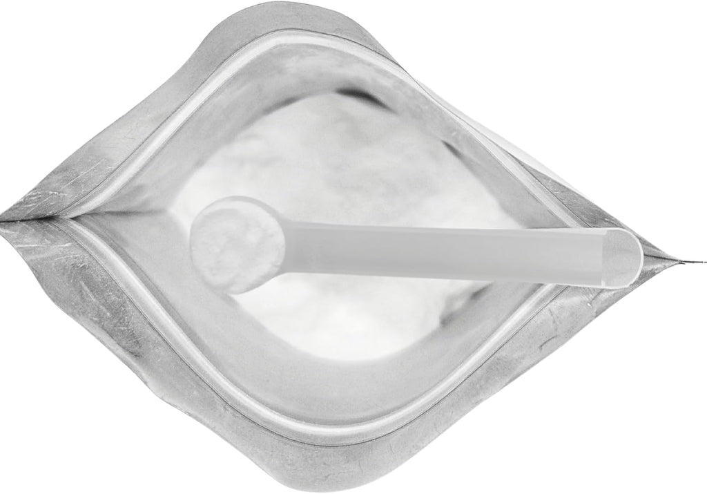 Close-up of Puravita unscented taurine powder showing the fine texture and included plastic measuring scoop.