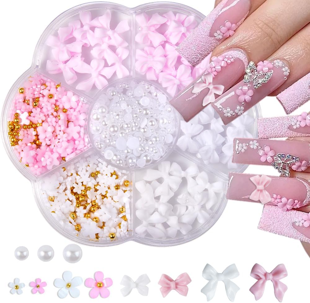 Qdsuh flower bow manicure kit front view showing pink and white three dimensional charms in a seven slot box.