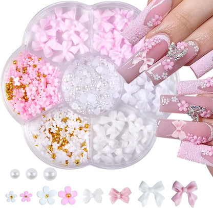 Qdsuh flower bow manicure kit front view showing pink and white three dimensional charms in a seven slot box.