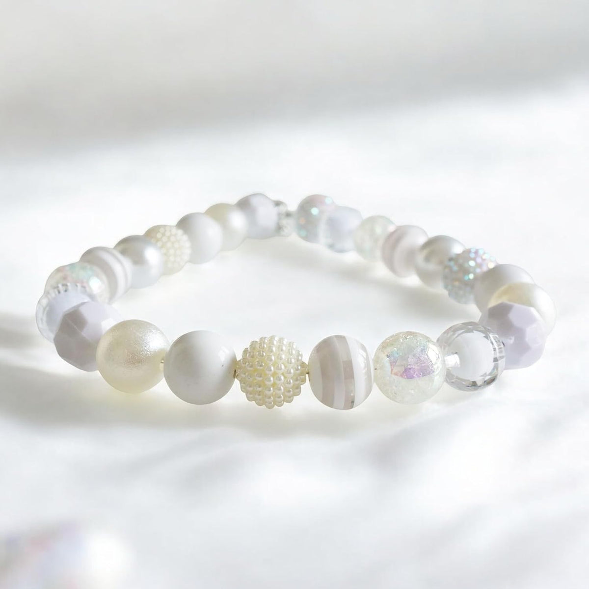 Decorative dog pearl necklace accessory being tested with the two finger safety rule on a medium breed.