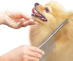Cat grooming tool removing loose undercoat fur from a plush cat.