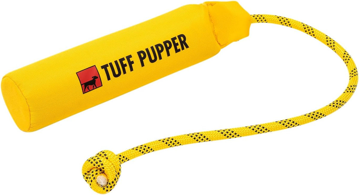 Human hand holding Tuff Pupper dog training bumper