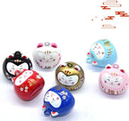 Close up of pink cartoon cat face on lucky bell pendant