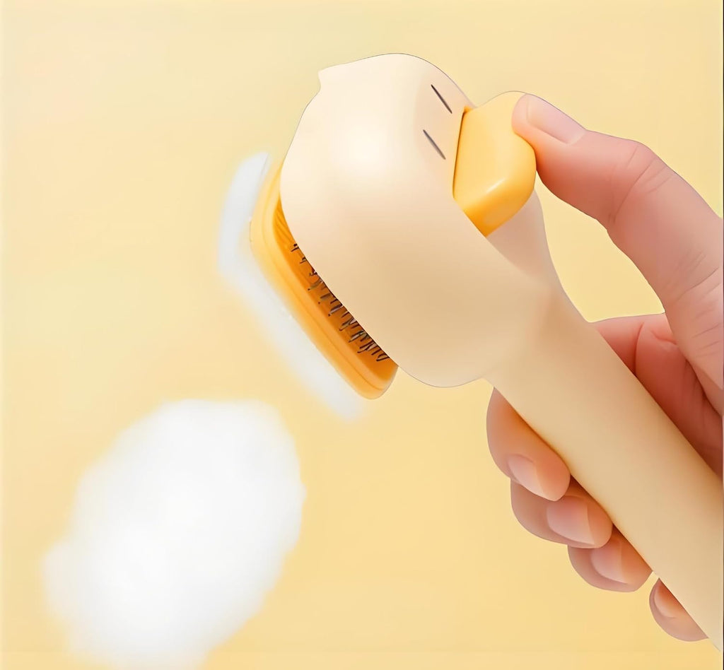 Yellow duck shaped cat grooming brush removing loose fur from undercoat.