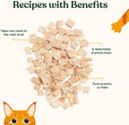 Crunchy freeze dried chicken breast cubes for cats being poured over kibble