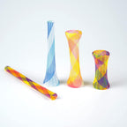 Assorted random colors of flexible plastic cat tube spring toys spread out on a floor