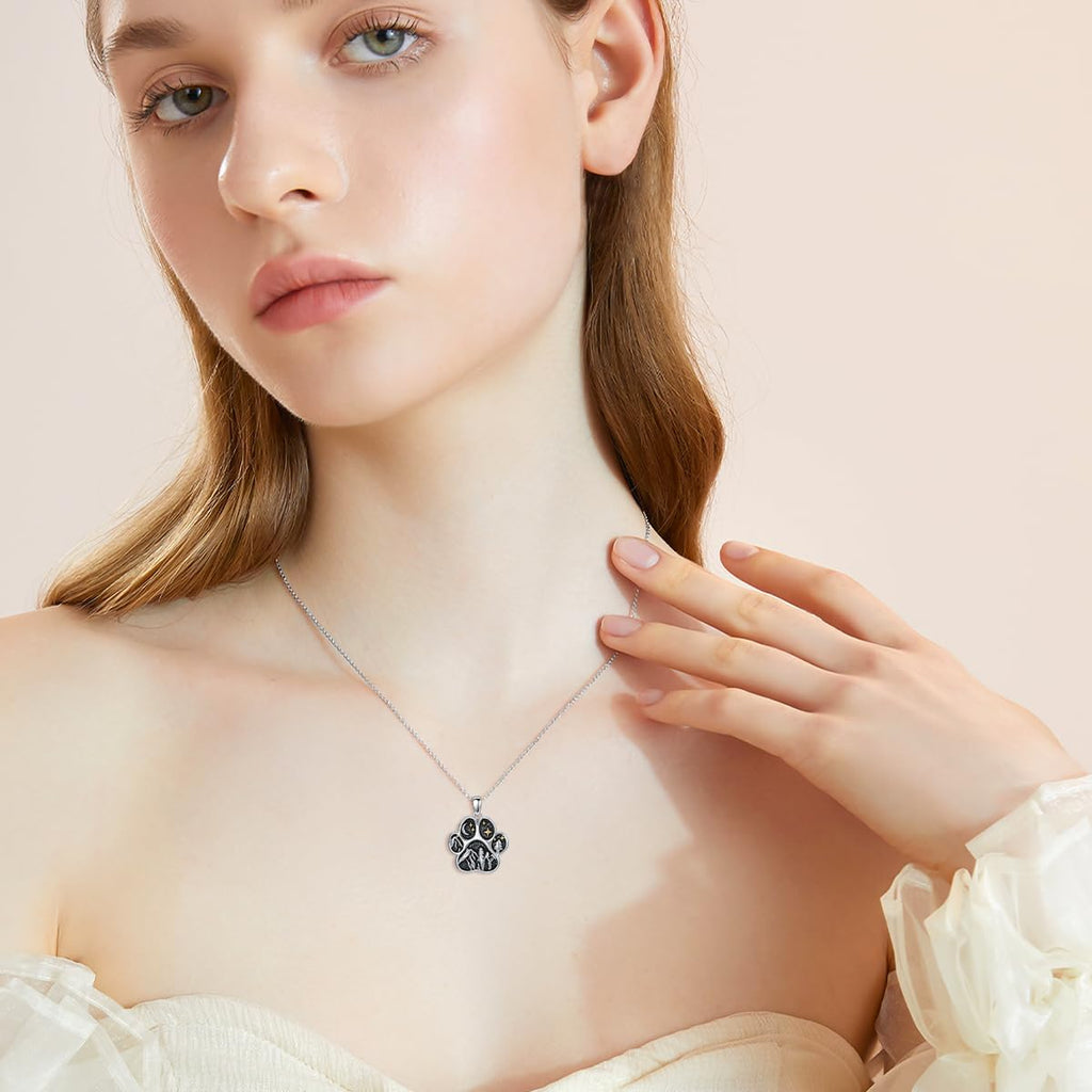Close up view of the hypoallergenic silver paw print mountain range pendant details