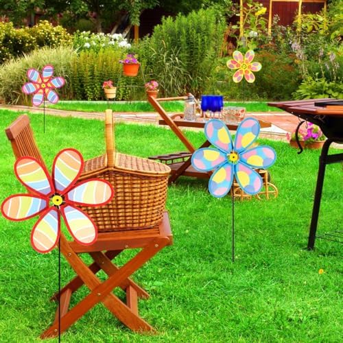Hadeeong wind spinners installed in a garden flower bed