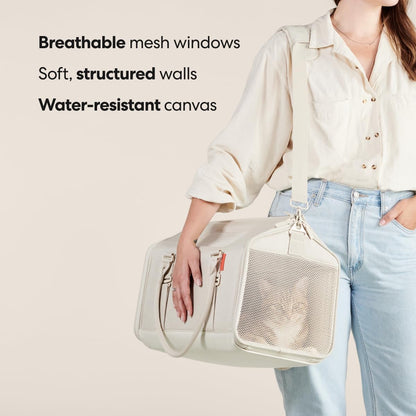 Large cat carrier with luggage trolley sleeve for airport travel.