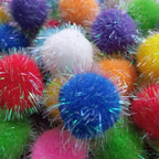 Premium imported USA pet supplies showing multiple sparkling plush balls for feline exercise.