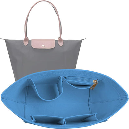 Lckaey handbag organizer insert being placed inside a large travel tote