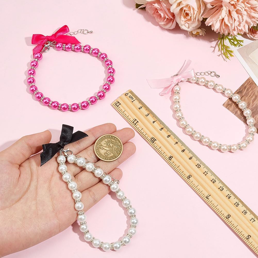 Close up view of the rhinestone charms and delicate ribbon bow on the pearl pet collar
