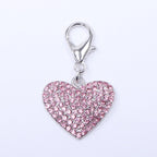 Close up of sparkling heart shaped rhinestone pet charm for small dogs