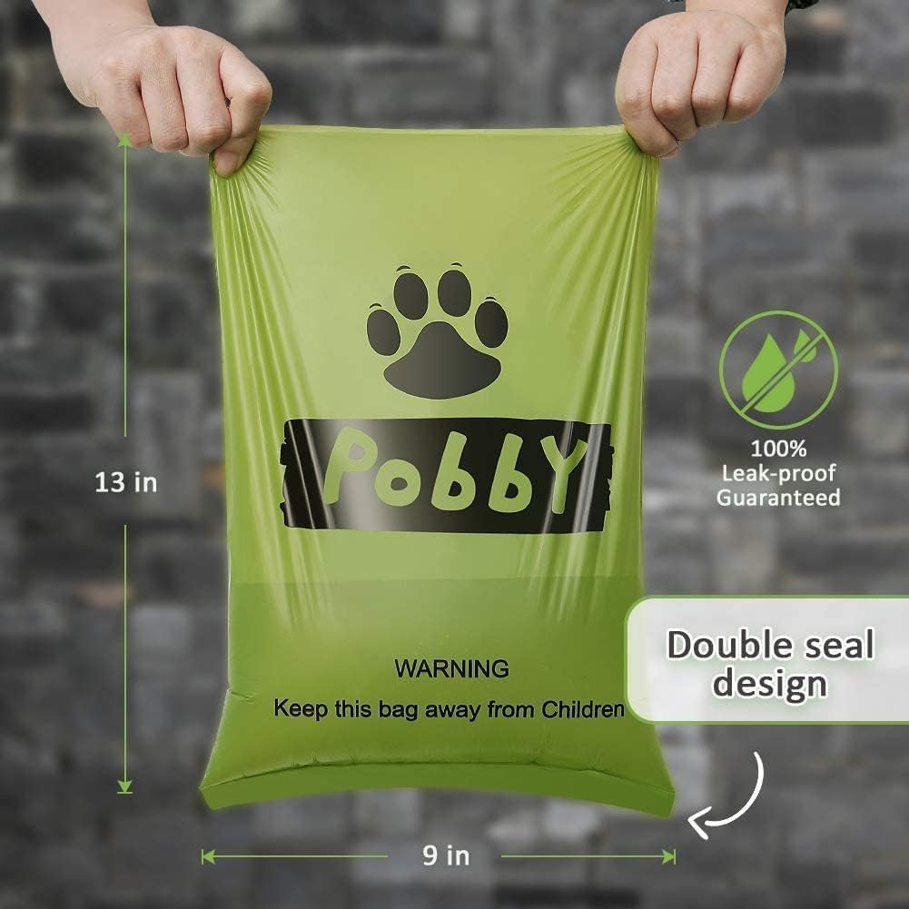Green biodegradable pet waste bags with black paw prints on rolls.