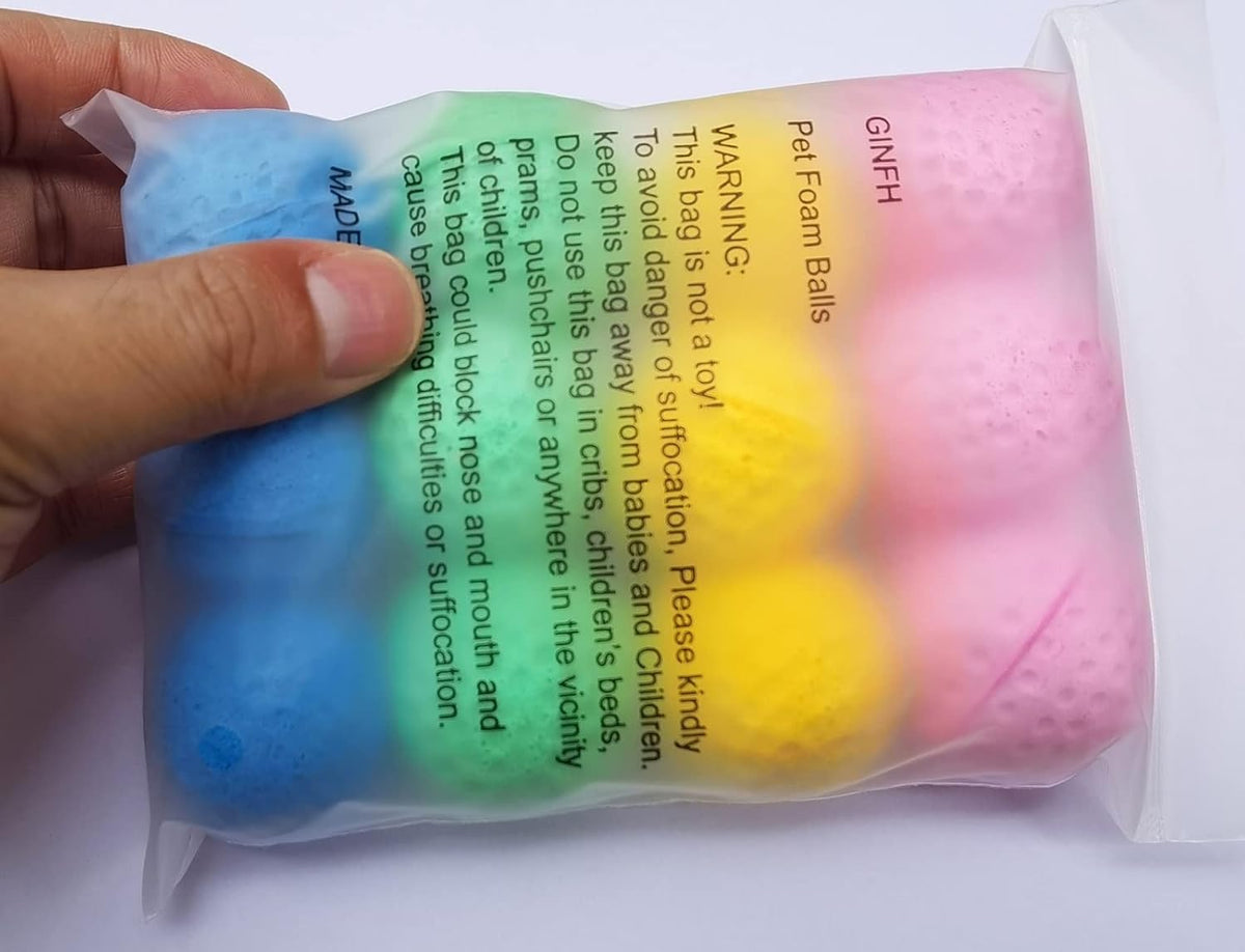 Close-up of GINFH latex foam cat toys showing the textured golf ball style design.