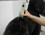 Side angle view of the sage green Wahl Professional KMC Plus dog grooming tool.
