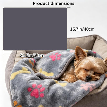 Soft flannel dog and cat throw blanket spread out on a sofa