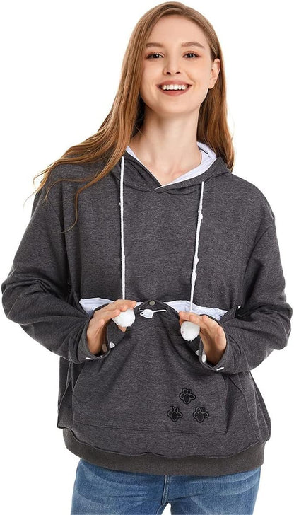 Model walking outdoors with a small puppy resting inside the LINYUCHEN pouch sweatshirt