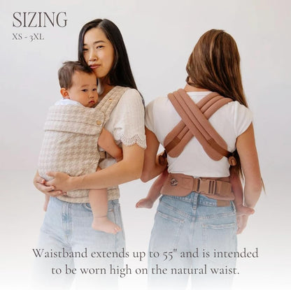 Parent using Mabē Monarch baby carrier in front-facing position