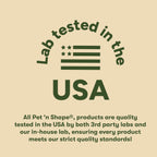 A small dog happily chewing on a Pet 'n Shape chicken wrapped rawhide twist snack