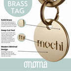 Modern minimal circular dog ID tag on a pet collar