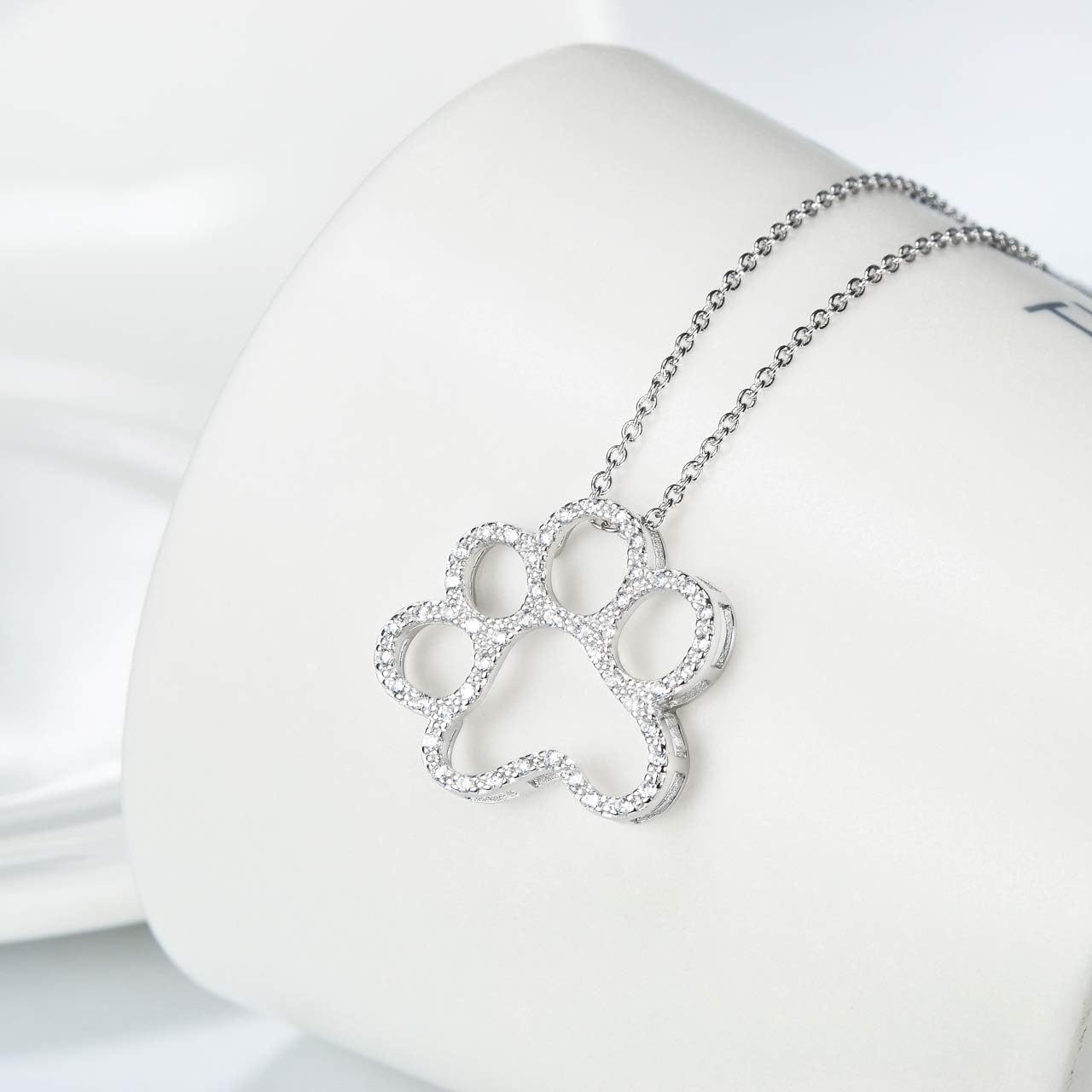 ONEFINITY 925 sterling silver paw necklace displayed inside its exquisite gift box