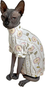 Cat wearing a stylish butterfly print shirt in a home setting