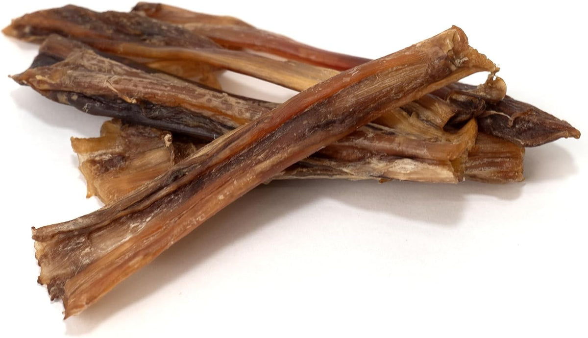 Lifestyle shot of Pawtitas ostrich chews on a wooden surface
