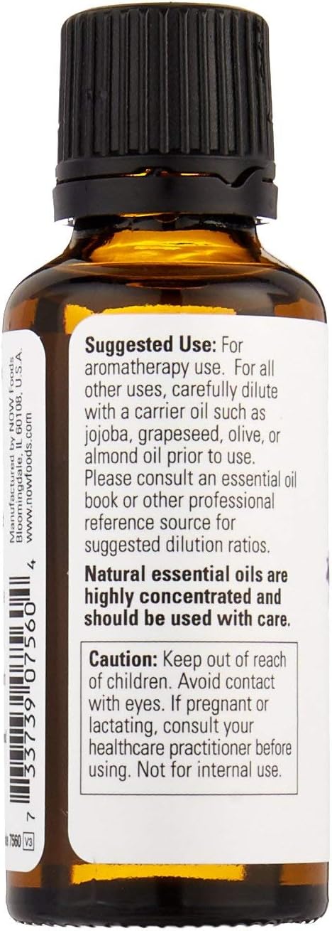 Steam distilled lavender essential oil from NOW Foods displayed next to fresh lavender flowers