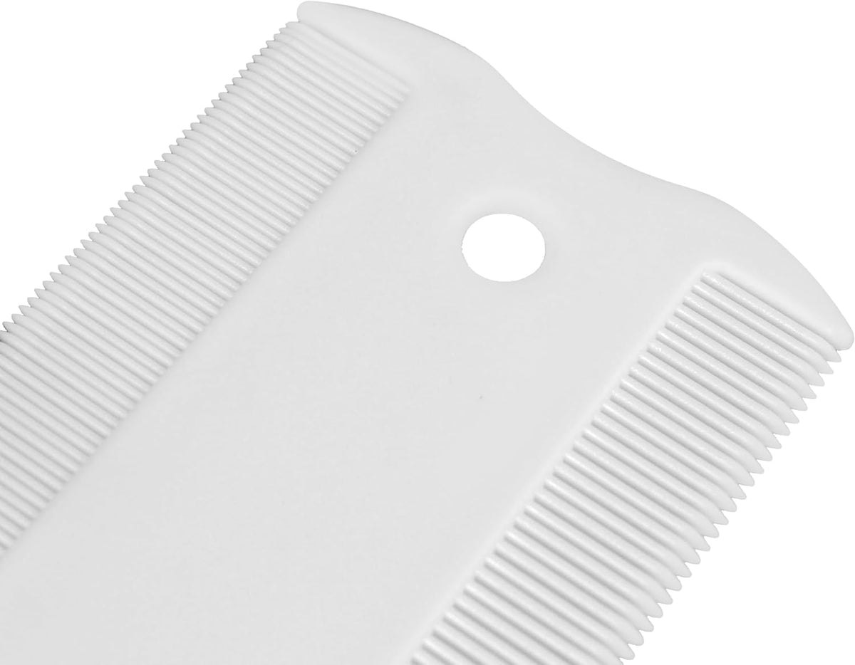 Groomer Essentials flea comb being used on a dog face