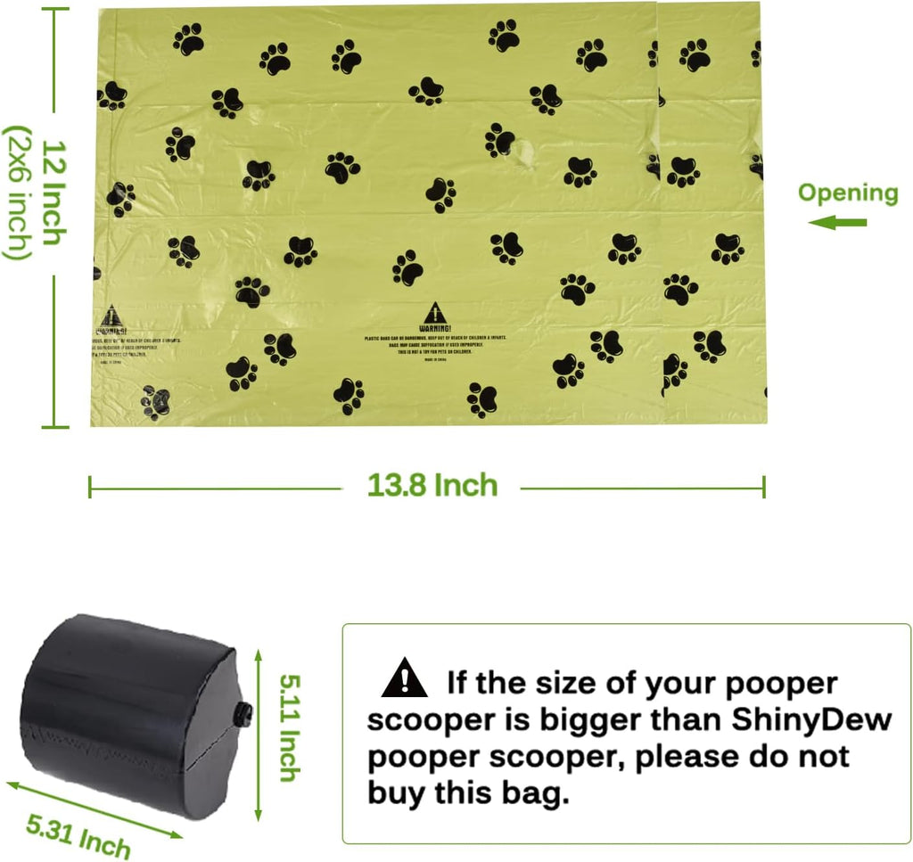 Oversized green pet waste rolls with black paw print graphics displayed on a flat surface.