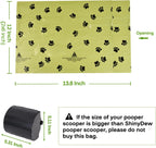 Oversized green pet waste rolls with black paw print graphics displayed on a flat surface.