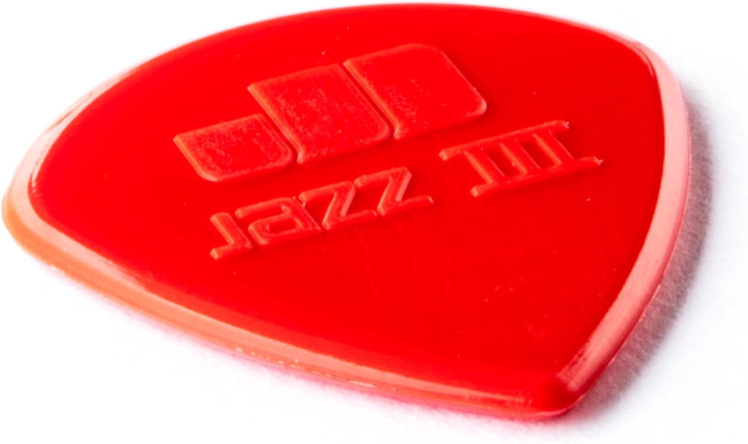 Close up of red 1.38mm heavy gauge plectrum showing sharp tip