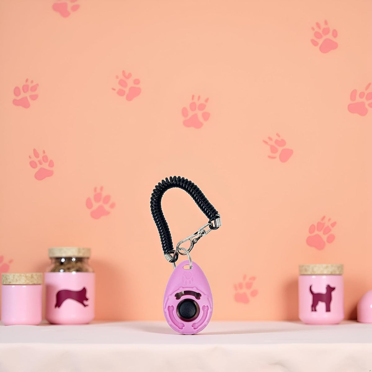 Ergonomic pink dog clicker with large easy press black button detailing