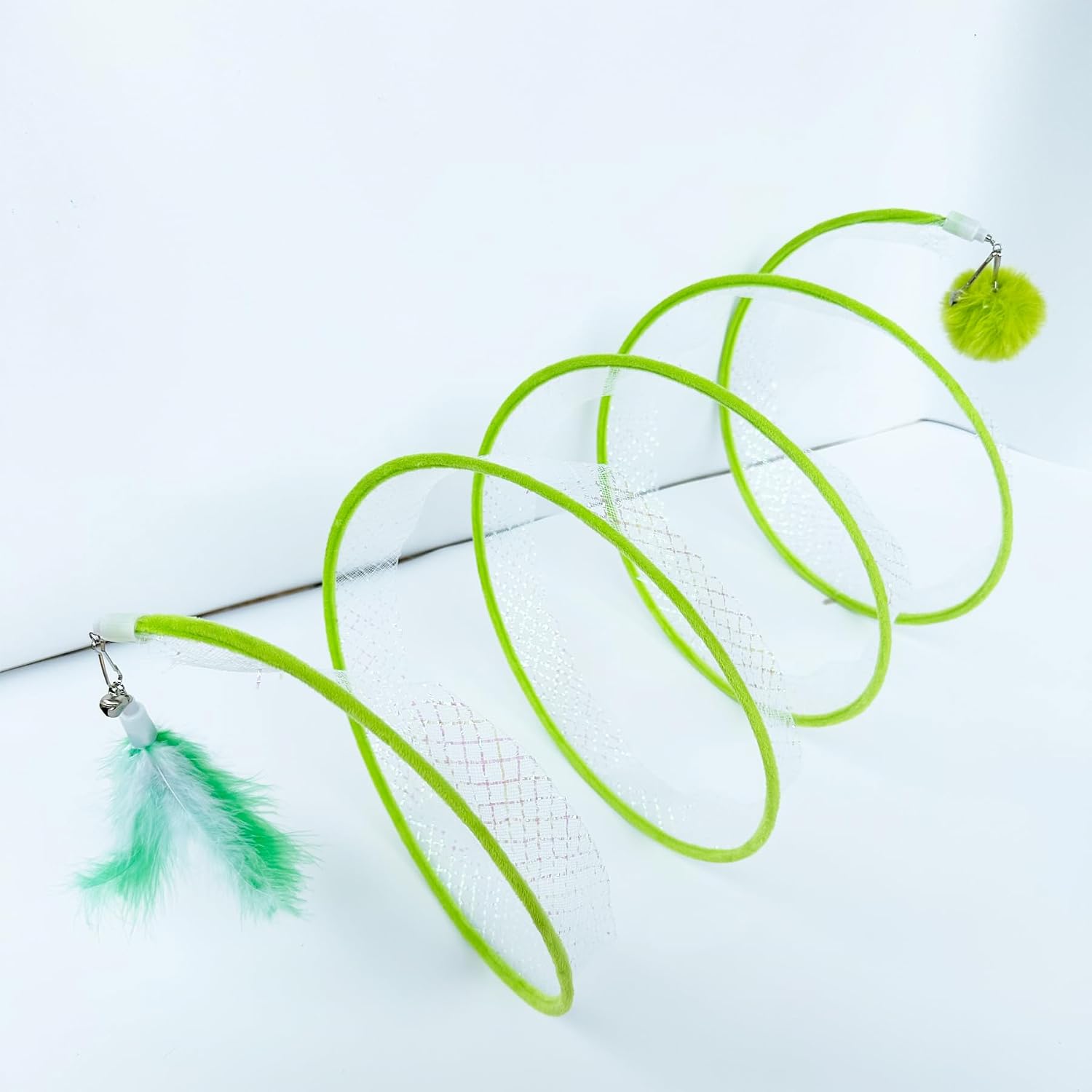 Close up view of the attached bell and feather tail teaser toy