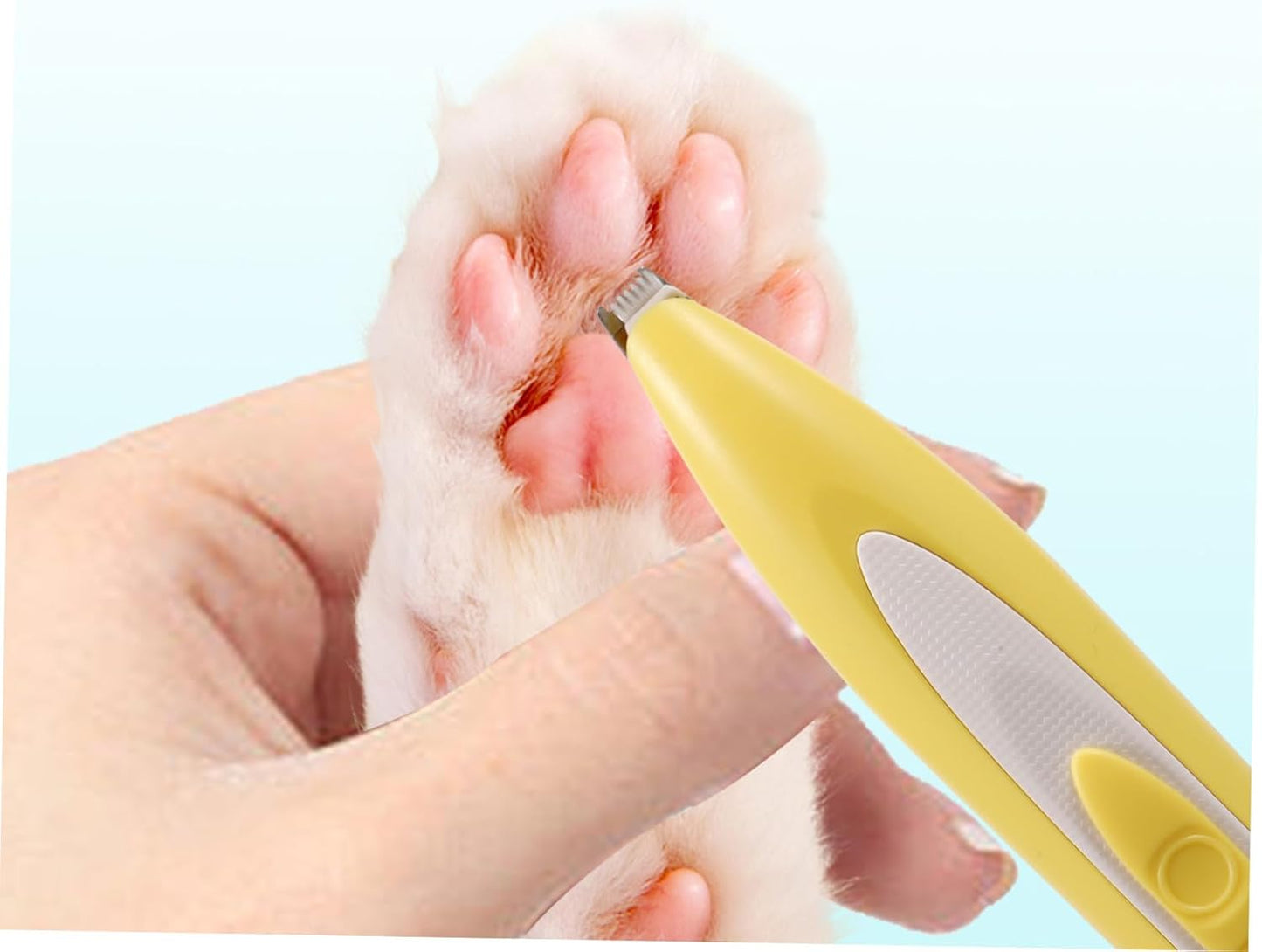 Ergonomic yellow pet clipper being used on a dog's paw pad.