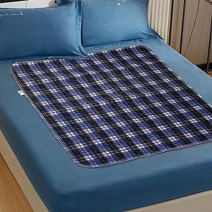 Washable incontinence sheet pad spread across a standard mattress demonstrating generous surface coverage