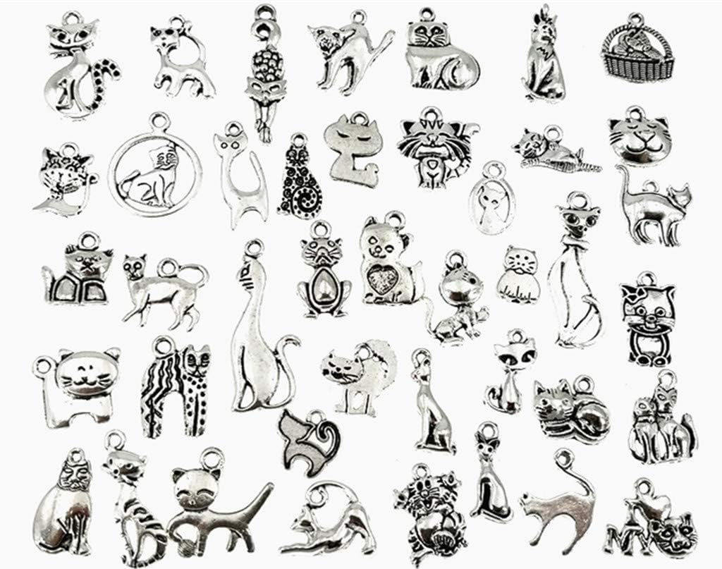 Collection of antique silver cat charms displayed flat