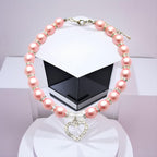Pink pearl dog collar with rhinestone heart charm pendant close up