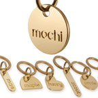 Onoma solid brass pet tag front view showing deep cut engraving